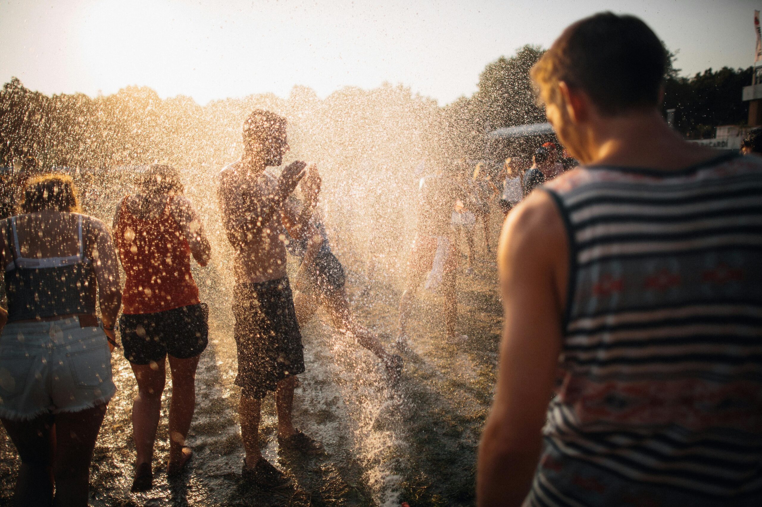 Menschen genießen die Wasserspritzer bei einem Sommermusikfestival in Budapest, Ungarn.